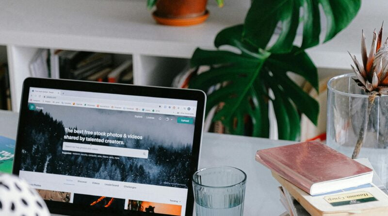 Person disconnecting from work by turning off their laptop in a cozy home setting after right to Disconnect law comes into effect.